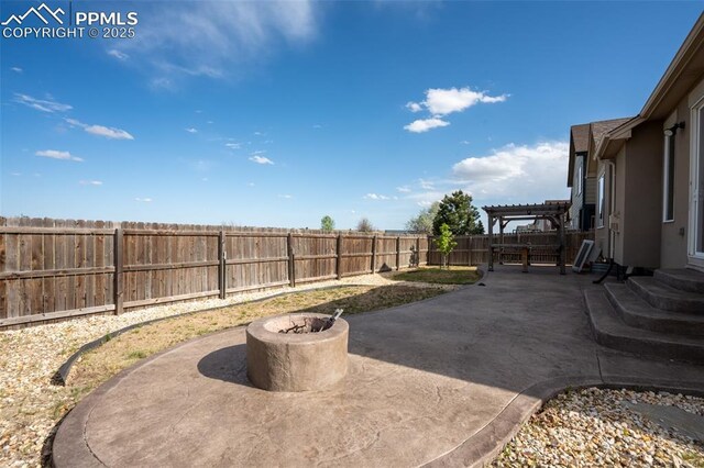 1985 Reed Grass Way, Colorado Springs, CO 80915 - fenced backyard featuring a patio, a pergola, and an outdoor fire pit