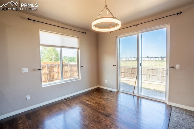 1985 Reed Grass Way, Colorado Springs, CO 80915 - unfurnished room featuring baseboards and dark wood-style floors