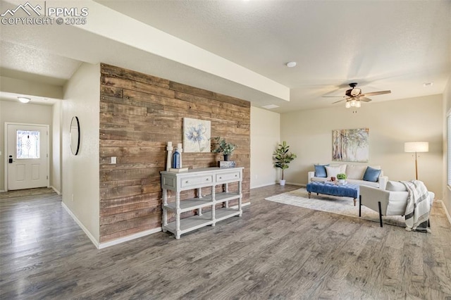 7923 Wagonwood Pl, Colorado Springs, CO 80908 - living area with wood finished floors, baseboards, a ceiling fan, and wood walls