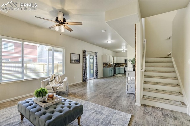 7923 Wagonwood Pl, Colorado Springs, CO 80908 - living room with a ceiling fan, baseboards, stairs, and light wood-style floors