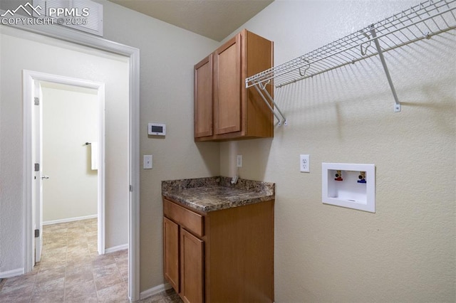 7923 Wagonwood Pl, Colorado Springs, CO 80908 - laundry area featuring washer hookup, cabinet space, and baseboards