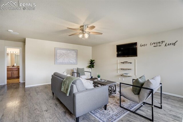7923 Wagonwood Pl, Colorado Springs, CO 80908 - living area with ceiling fan, wood finished floors, and baseboards