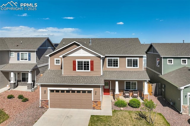 7923 Wagonwood Pl, Colorado Springs, CO 80908 - craftsman-style house featuring covered porch, stone siding, a shingled roof, and a garage