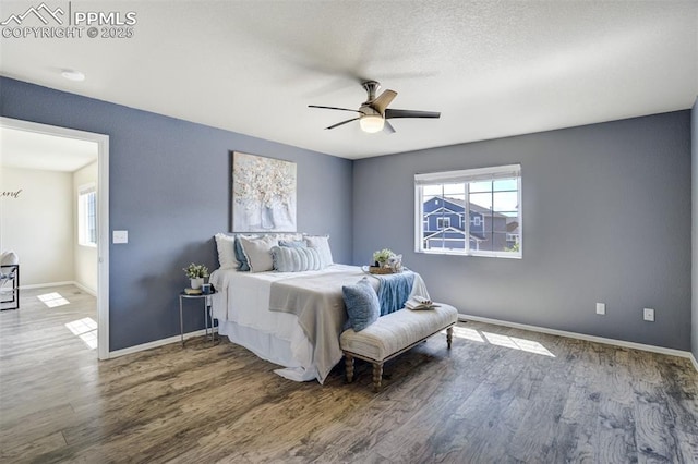 7923 Wagonwood Pl, Colorado Springs, CO 80908 - bedroom with wood finished floors, baseboards, and a ceiling fan