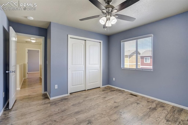 7923 Wagonwood Pl, Colorado Springs, CO 80908 - unfurnished bedroom featuring a closet, wood finished floors, and baseboards