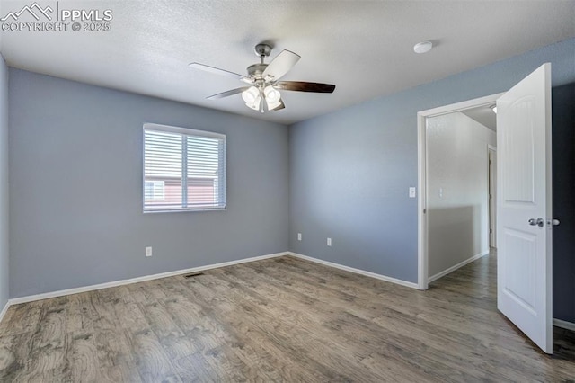 7923 Wagonwood Pl, Colorado Springs, CO 80908 - empty room featuring a ceiling fan, wood finished floors, and baseboards