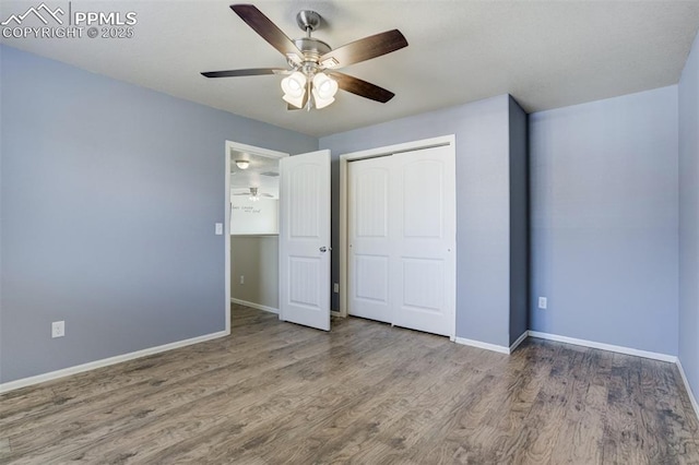 7923 Wagonwood Pl, Colorado Springs, CO 80908 - unfurnished bedroom featuring baseboards, wood finished floors, a closet, and ceiling fan