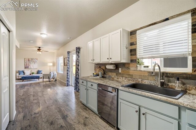7923 Wagonwood Pl, Colorado Springs, CO 80908 - kitchen featuring dishwasher, a sink, healthy amount of natural light, and dark wood-type flooring