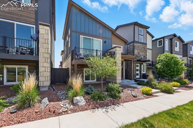 2454 Jazzy Lady Ct, Colorado Springs, CO 80922 - modern home with stone siding, board and batten siding, and a balcony