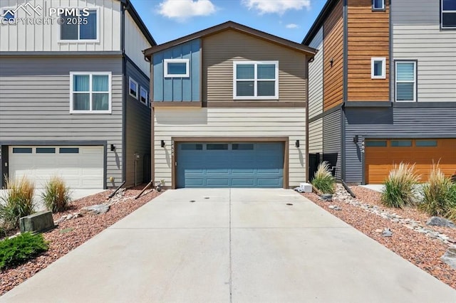 2454 Jazzy Lady Ct, Colorado Springs, CO 80922 - contemporary home featuring board and batten siding, an attached garage, and driveway