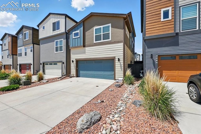 2454 Jazzy Lady Ct, Colorado Springs, CO 80922 - view of front facade featuring driveway, a garage, a residential view, and board and batten siding