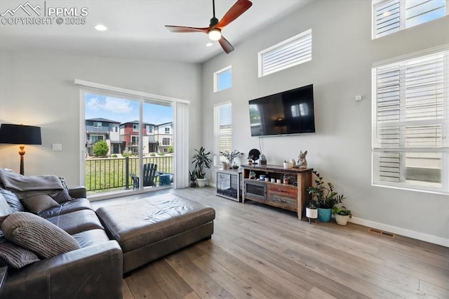 2454 Jazzy Lady Ct, Colorado Springs, CO 80922 - living area featuring a ceiling fan, wood finished floors, recessed lighting, baseboards, and a towering ceiling