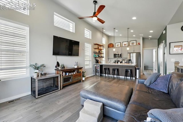 2454 Jazzy Lady Ct, Colorado Springs, CO 80922 - living area featuring ceiling fan, baseboards, recessed lighting, light wood-style flooring, and a high ceiling