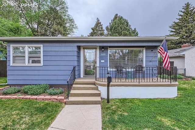 1609 Palmer Park Blvd, Colorado Springs, CO 80909 - view of front of home with a front yard and a porch