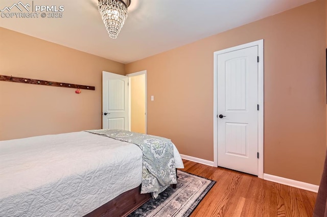 1609 Palmer Park Blvd, Colorado Springs, CO 80909 - bedroom featuring light wood-type flooring, baseboards, and a chandelier