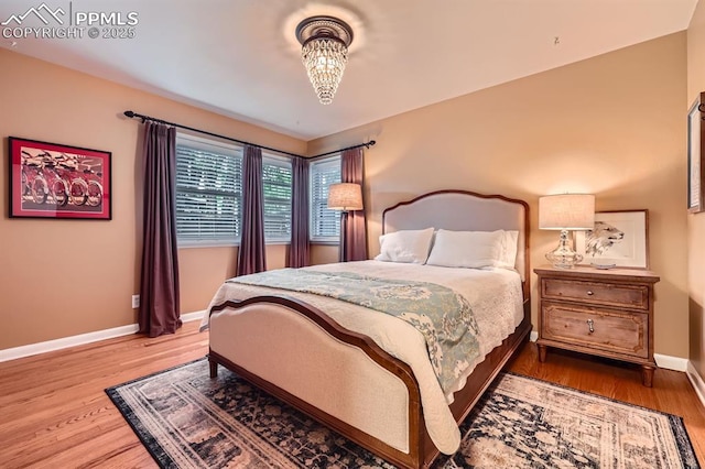 1609 Palmer Park Blvd, Colorado Springs, CO 80909 - bedroom with wood finished floors, baseboards, and a chandelier
