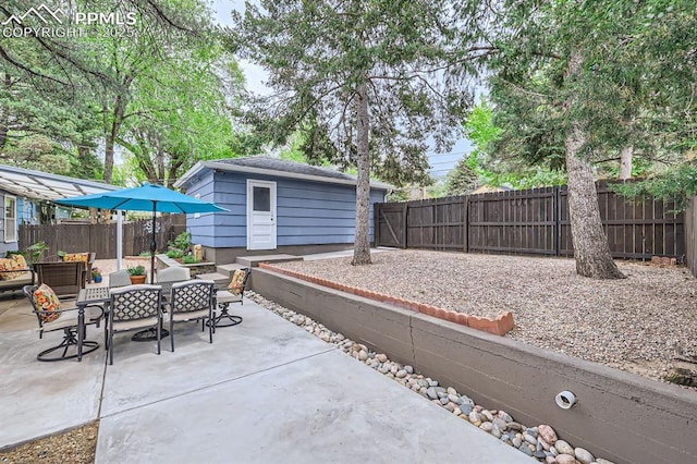 1609 Palmer Park Blvd, Colorado Springs, CO 80909 - fenced backyard with a patio area, outdoor dining space, and an outbuilding