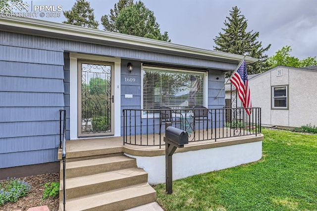 1609 Palmer Park Blvd, Colorado Springs, CO 80909 - doorway to property with covered porch and a lawn