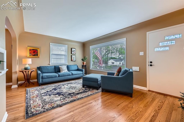 1609 Palmer Park Blvd, Colorado Springs, CO 80909 - living area featuring wood finished floors, arched walkways, and baseboards