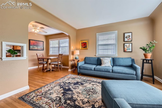1609 Palmer Park Blvd, Colorado Springs, CO 80909 - living room with baseboards, light wood-type flooring, a ceiling fan, and arched walkways