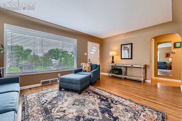 1609 Palmer Park Blvd, Colorado Springs, CO 80909 - living room with arched walkways, wood finished floors, and baseboards