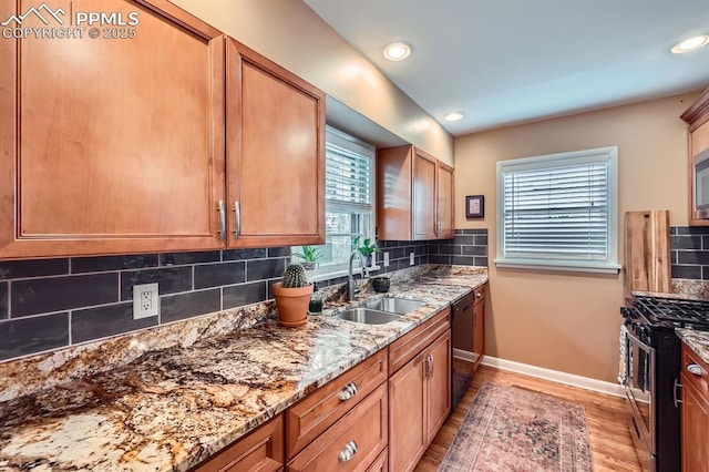 1609 Palmer Park Blvd, Colorado Springs, CO 80909 - kitchen with gas stove, a sink, healthy amount of natural light, light wood-style flooring, and recessed lighting
