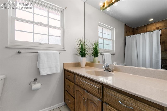490 Wintery Cir, Colorado Springs, CO 80919 - bathroom featuring toilet, vanity, curtained shower, and baseboards