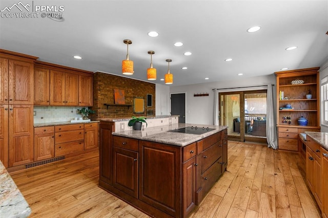 490 Wintery Cir, Colorado Springs, CO 80919 - kitchen featuring black electric cooktop, recessed lighting, light wood finished floors, open shelves, and decorative backsplash