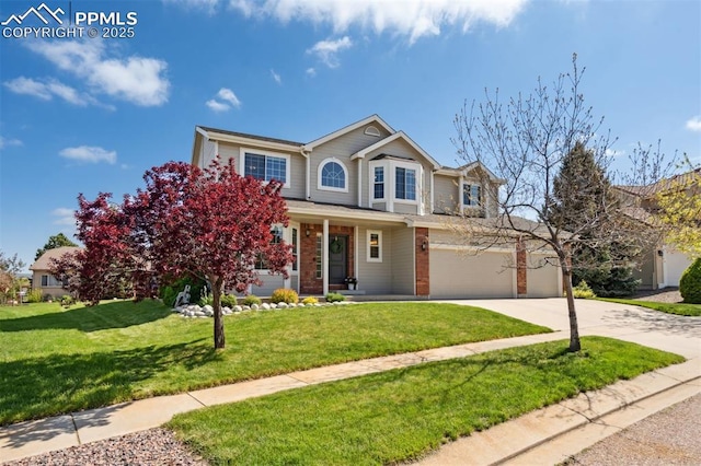 9969 Bridgeport Dr, Colorado Springs, CO 80920 - traditional home with concrete driveway, a front yard, brick siding, a garage, and covered porch