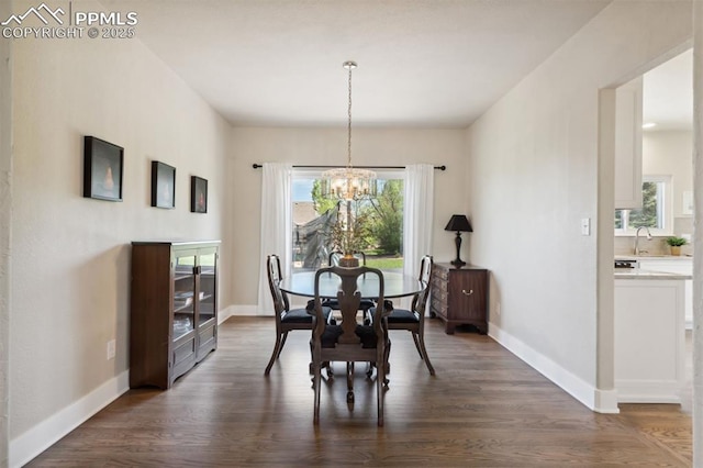 9969 Bridgeport Dr, Colorado Springs, CO 80920 - dining area with a chandelier, dark wood-style floors, and baseboards