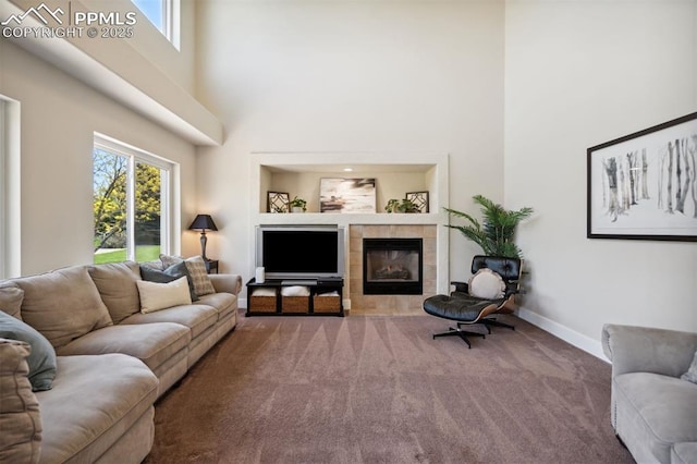 9969 Bridgeport Dr, Colorado Springs, CO 80920 - living room with a high ceiling, carpet, a fireplace, and baseboards
