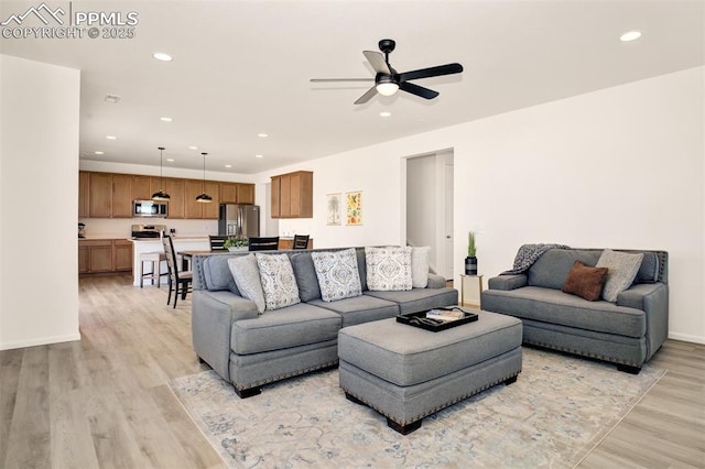 10046 Keating Dr, Peyton, CO 80831 - living area featuring light wood finished floors, recessed lighting, a ceiling fan, and baseboards