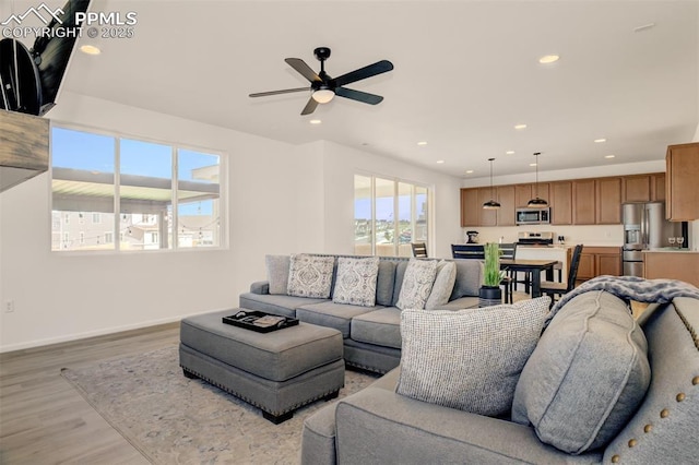 10046 Keating Dr, Peyton, CO 80831 - living area featuring light wood-style floors, ceiling fan, recessed lighting, and baseboards