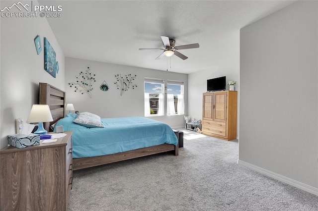 carpeted bedroom with baseboards and ceiling fan