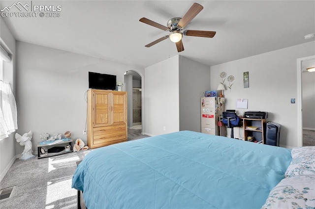 bedroom with carpet, arched walkways, baseboards, and refrigerator