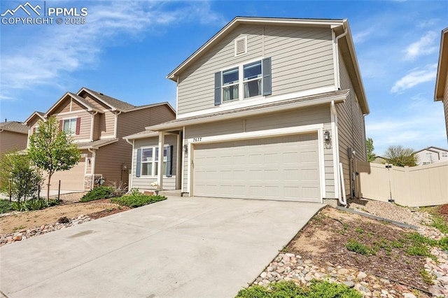 traditional home featuring a garage and concrete driveway