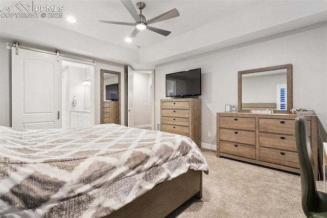 5799 Adkisson Pl, Colorado Springs, CO 80924 - bedroom with light carpet, ensuite bath, a barn door, baseboards, and a ceiling fan