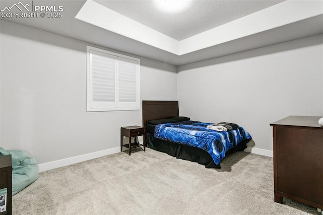 5799 Adkisson Pl, Colorado Springs, CO 80924 - carpeted bedroom with a tray ceiling and baseboards