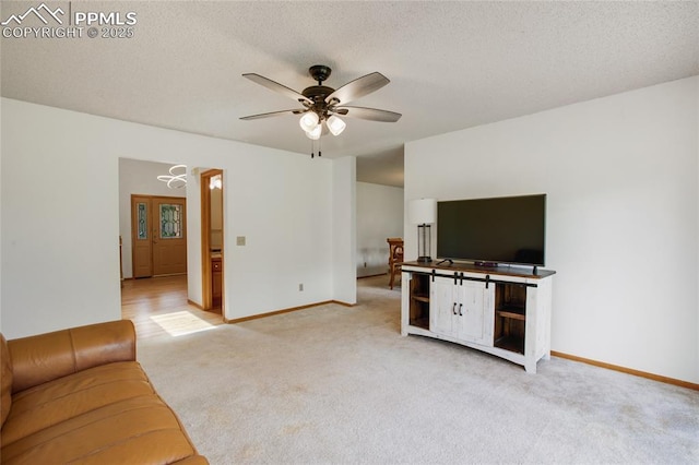 390 E Stirrup Trl, Monument, CO 80132 - unfurnished living room with carpet flooring, ceiling fan, baseboards, and a textured ceiling