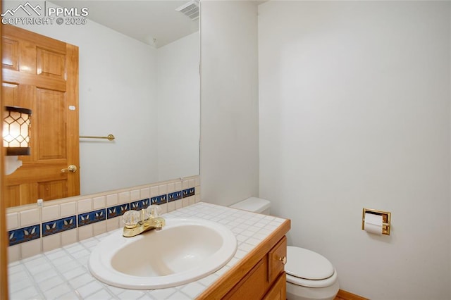 390 E Stirrup Trl, Monument, CO 80132 - half bathroom with toilet, vanity, and baseboards