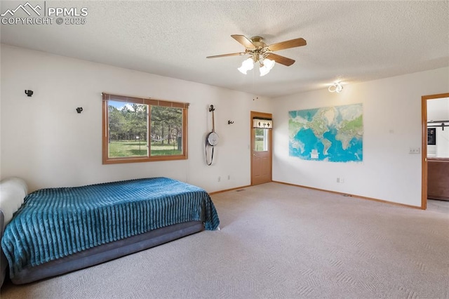 390 E Stirrup Trl, Monument, CO 80132 - bedroom with carpet flooring, a textured ceiling, baseboards, and ceiling fan