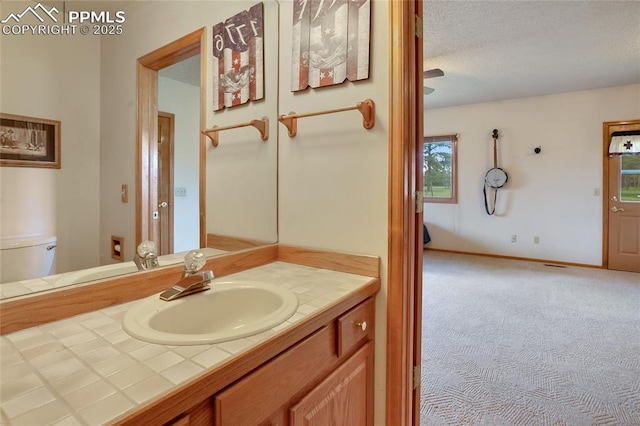 390 E Stirrup Trl, Monument, CO 80132 - bathroom with vanity, toilet, and a textured ceiling