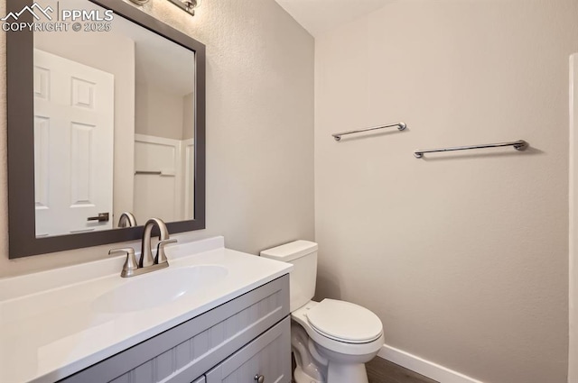 6491 Ferndale Dr, Colorado Springs, CO 80923 - half bath featuring toilet, vanity, and baseboards