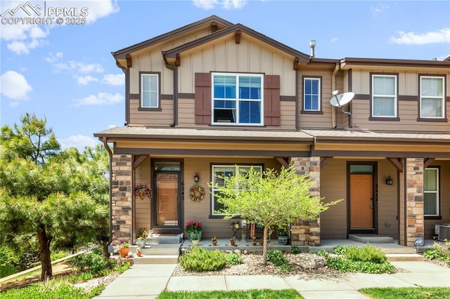 6243 Fowler Mill Pt, Colorado Springs, CO 80923 - view of front facade featuring a porch, stone siding, board and batten siding, and cooling unit
