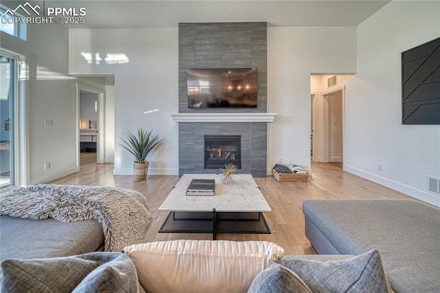 9473 Bugaboo Dr, Colorado Springs, CO 80924 - living area with a tile fireplace, wood finished floors, and baseboards