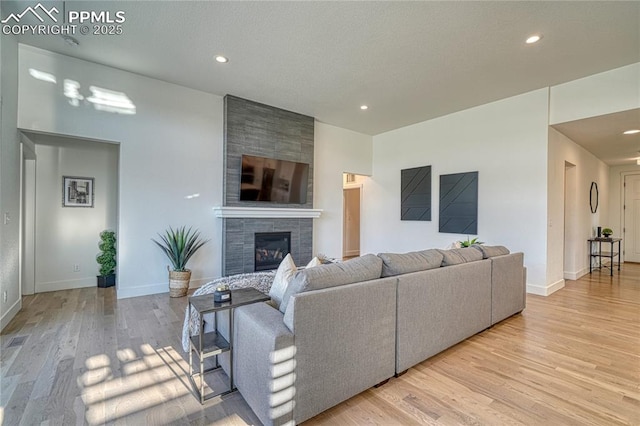 9473 Bugaboo Dr, Colorado Springs, CO 80924 - living area with wood finished floors, recessed lighting, a large fireplace, and baseboards