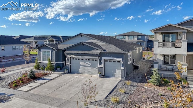 9473 Bugaboo Dr, Colorado Springs, CO 80924 - view of front facade featuring a residential view, an attached garage, concrete driveway, stucco siding, and roof with shingles
