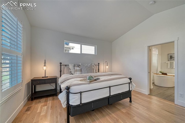 9473 Bugaboo Dr, Colorado Springs, CO 80924 - bedroom with lofted ceiling, light wood-style flooring, baseboards, and ensuite bathroom