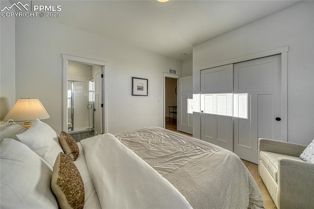 9473 Bugaboo Dr, Colorado Springs, CO 80924 - bedroom with light wood-type flooring, ensuite bath, and a closet