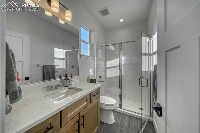 9473 Bugaboo Dr, Colorado Springs, CO 80924 - full bathroom with toilet, vanity, a stall shower, and recessed lighting